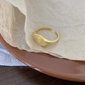 Detail of vintage 925 sterling silver sun signet ring with adjustable gold open band