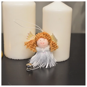 Detail of plush angel Christmas ornament featuring white tinsel dress and small metal bell