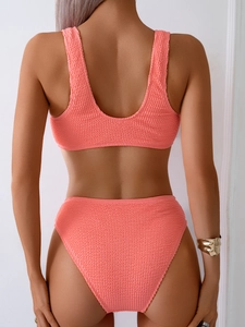 Detail of coral pink smocked bikini with high waist bottom and deep U-back design