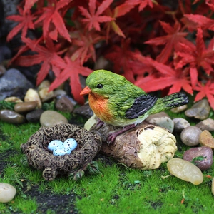 Garden resin miniature bird figurine set with nest and eggs on red maple leaf background