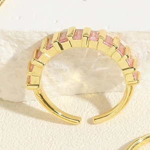 Detail of gold-plated adjustable ring featuring rectangular pink zircon stone settings