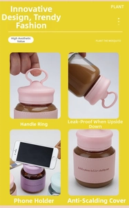 Detail view of portable glass cup with pink leather sleeve and lid acting as phone holder