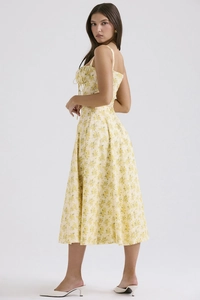 Detailed back view of a yellow floral slip dress showing the slim fit and flowing A-line cut