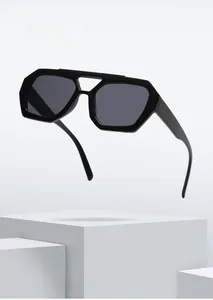 Close-up of black geometric hexagonal sunglasses with premium dark tinted UV lenses