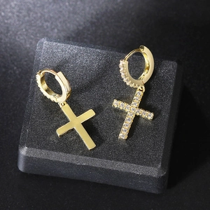 Close-up of gold-plated cross earrings featuring cubic zirconia and a polished finish