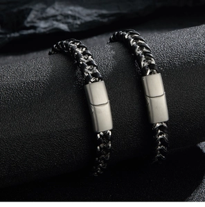 Close-up of dual multilayer braided leather bracelets with stainless steel magnetic clasps