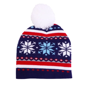 Detailed knit texture of red and blue Christmas beanie with white pom-pom and snowflake