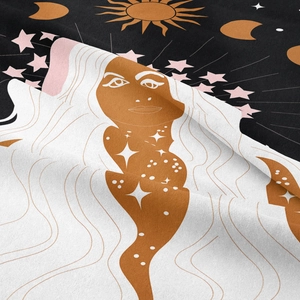 Close-up of bohemian tapestry showing mystical sun, moon motifs and coarse fabric texture