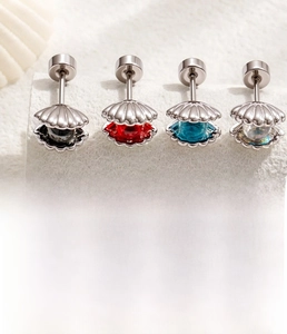 Detail view of shell zircon ear studs with titanium steel posts and size specifications