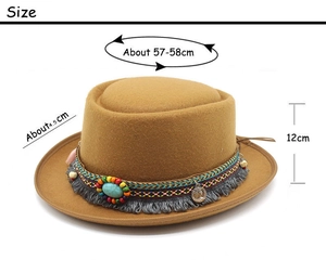 Detail of brown wool fedora with ethnic woven band, colorful beads and metal coin charm