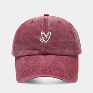 Detail of burgundy washed cotton baseball cap featuring white double heart embroidery