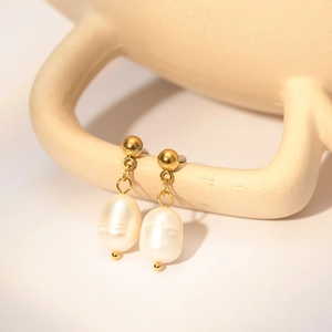 French vintage freshwater pearl drop earrings in 18k gold plated steel shown on handle
