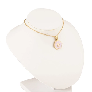 Gold hexagon necklace with pink shell inlay and letter B pendant on mannequin