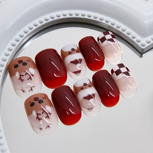 Christmas theme press-on nails with Santa and reindeer patterns in red and brown colors