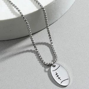 Polished stainless steel chain necklace with an oval football pendant on grey background
