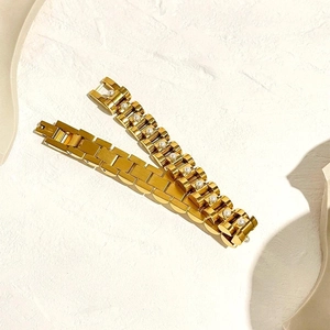 Luxurious 18K gold plated watch chain bracelet set with white pearls on stone background