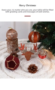 Close-up of velvet geometric spheres and sequin reindeer heads on knit surface