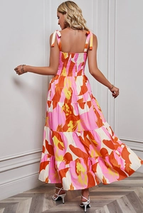 Detail view of pink floral dress featuring backless tie-up straps and tiered skirt