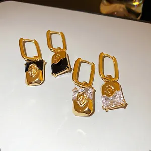 Vintage gold plated lion head earrings with geometric diamonds and rectangle gems