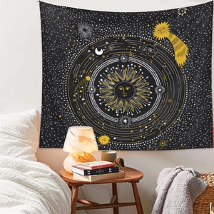 Detail of celestial tapestry featuring sun, moon, and stars on a black fabric background