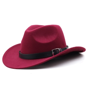 Detail of burgundy wool felt western hat with black leather band and silver metal buckle