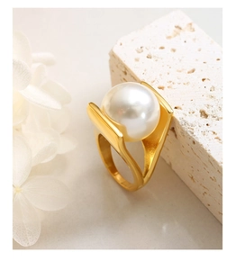 Detailed view of Y-shaped 18k gold plated ring with a large white pearl on stone