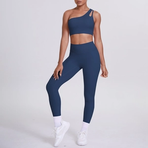 Detail of one-shoulder yoga bra and high-waist leggings in navy blue athletic set