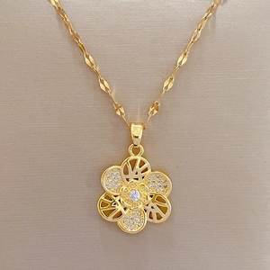Elegant rotating flower pendant necklace in gold finish with sparkling zircon inlay