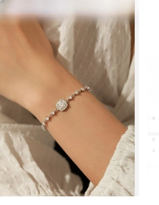 Detail of s925 silver bracelet featuring a square moissanite stone on a woman's wrist