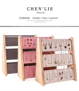 Three-tier wooden necklace display stands with premium velvet pads in diverse colors