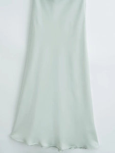 Detail shot of smooth mint green satin fabric with elegant silk-like texture and sheen