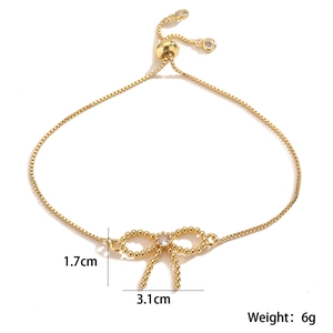 Detail view of gold bow bracelet with cubic zirconia and 1.7x3.1cm dimension markers