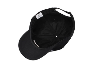 Detailed interior of black cotton baseball cap showing 100% cotton label and stitching