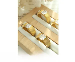 Macro detail of four gold plated vintage rings with square zircon and textured bands