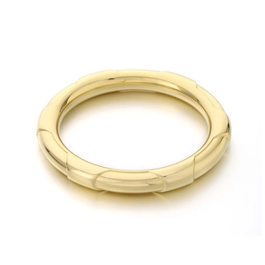Polished gold stainless steel bangle with ribbed texture and minimalist round design
