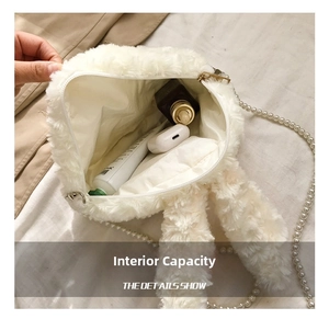 Macro view of plush rabbit bag interior with pearl chain strap and zipper opening