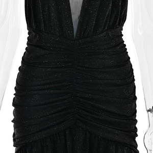 Detail of black sparkling dress featuring sequins and elegant waist pleating texture