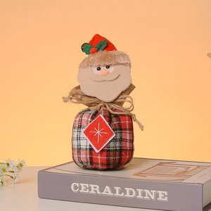 Detailed view of burlap Christmas gift bag with 3D Santa plush and drawstring closure