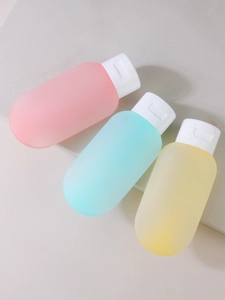 Macro view of portable 60ml silicone travel squeeze bottles in pink blue and yellow