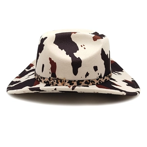 Classic western cowboy hat featuring brown cow print and leopard band with buckle