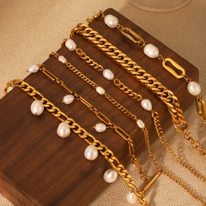 6pcs set of golden Figaro and Cuban chains with natural freshwater pearls on wood
