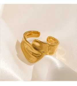 Detailed view of 18K gold plated open ring with irregular lava texture on silk