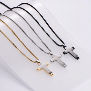 Three-piece set of two-tone stainless steel cross necklaces in gold, silver, and black finish