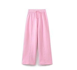 Detailed view of pink wide-leg sweatpants featuring high-waisted drawstring and center seam
