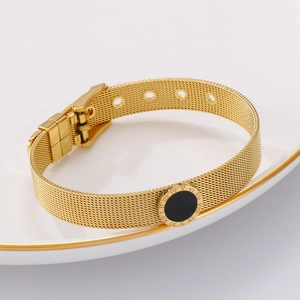 Detail of 18k gold mesh watch band bracelet with Roman numerals and black onyx inlay