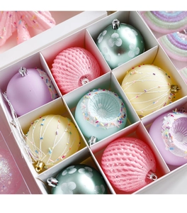 Detail of pink and purple pastel Christmas candy ornaments in a white divided gift box