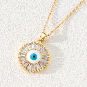 Macro shot of evil eye pendant with blue enamel and sparkling cubic zirconia stones
