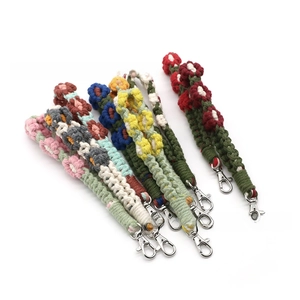 Close-up of handmade crochet flower keychains in multiple vibrant colors with metal clasps