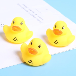 Three mini yellow rubber ducks for baby bath with orange beaks and cute eye designs