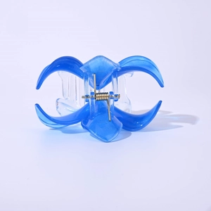 Detailed view of large blue translucent plumeria hair claw with visible spring